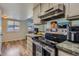 The kitchen features stainless appliances, granite countertops, and modern flooring at 3354 S Flower St # 14, Lakewood, CO 80227