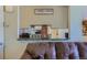 Kitchen pass-through features bar countertop and decorative lighting at 3354 S Flower St # 14, Lakewood, CO 80227
