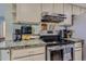 A kitchen with updated cabinets, stainless steel appliances, and granite countertops at 3354 S Flower St # 14, Lakewood, CO 80227