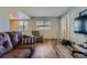 Welcoming living room with wood flooring, neutral walls, large windows, and comfortable seating at 3354 S Flower St # 14, Lakewood, CO 80227