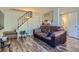 Inviting living room featuring wood floors, stairs, and a pass-through to the kitchen at 3354 S Flower St # 14, Lakewood, CO 80227