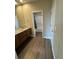 Bathroom featuring hardwood floors, granite countertops, undermount sinks, and a shower/tub combo at 9715 Taylor River Cir, Littleton, CO 80125