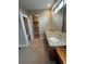 Spacious primary bathroom featuring a dual sink vanity with granite countertops and a walk-in closet at 9715 Taylor River Cir, Littleton, CO 80125