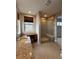 Bright bathroom featuring a glass shower, a vanity with granite countertops, and a built-in desk at 9715 Taylor River Cir, Littleton, CO 80125