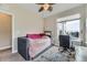 Cozy bedroom featuring a daybed, large window, and a comfortable workspace at 9715 Taylor River Cir, Littleton, CO 80125
