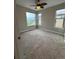 Bedroom featuring a ceiling fan, neutral walls, carpeted floors, and windows letting in natural light at 9715 Taylor River Cir, Littleton, CO 80125