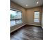 Bright bedroom featuring wood floors, neutral walls, recessed lights, and windows letting in natural light at 9715 Taylor River Cir, Littleton, CO 80125