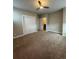Spacious bedroom featuring a ceiling fan, carpeted floors and closet with double doors at 9715 Taylor River Cir, Littleton, CO 80125