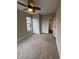 Bedroom featuring a ceiling fan, neutral walls, carpeted floors, and an ensuite bathroom at 9715 Taylor River Cir, Littleton, CO 80125