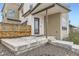 Stylish front porch with a modern design, concrete steps, and a sleek black front door at 9715 Taylor River Cir, Littleton, CO 80125