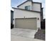 Two-car garage with a concrete driveway and modern exterior at 9715 Taylor River Cir, Littleton, CO 80125