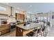 Modern kitchen featuring a granite island, stainless steel appliances, and seamless access to the living space at 9715 Taylor River Cir, Littleton, CO 80125