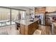 Gourmet kitchen featuring a large center island with a sink, stainless steel appliances, and sleek cabinetry at 9715 Taylor River Cir, Littleton, CO 80125