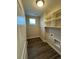 Efficient laundry room with shelving, window, and modern flooring and hookups at 9715 Taylor River Cir, Littleton, CO 80125