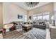 Bright living room featuring high ceilings, large windows, and comfortable seating area with stylish decor at 9715 Taylor River Cir, Littleton, CO 80125