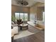 Inviting living room with large windows and a decorative ceiling fan at 9715 Taylor River Cir, Littleton, CO 80125