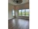 Modern living area features hardwood floors, high ceilings, and large windows with backyard views at 9715 Taylor River Cir, Littleton, CO 80125