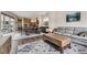 Spacious open-concept living and dining area with hardwood floors and a comfortable seating arrangement at 9715 Taylor River Cir, Littleton, CO 80125