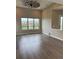 Beautiful living room featuring wood flooring, ceiling fan, and large window views of the backyard at 9715 Taylor River Cir, Littleton, CO 80125