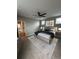 Spacious main bedroom with plush carpet, fan, and decoratively adorned with abstract artwork at 9715 Taylor River Cir, Littleton, CO 80125