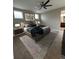 Spacious main bedroom features a comfortable bed, ceiling fan, and neutral carpet and walls at 9715 Taylor River Cir, Littleton, CO 80125