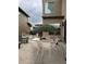 Cozy outdoor patio dining area with umbrella, modern wooden furniture, and concrete flooring at 9715 Taylor River Cir, Littleton, CO 80125