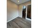 Neutral interior view with modern hard surface flooring, large door, and staircase access at 9715 Taylor River Cir, Littleton, CO 80125