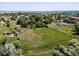 Picturesque aerial perspective of a sprawling acreage property with mature trees in a serene, suburban environment at 12196 W Belleview Dr, Littleton, CO 80127