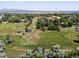 Stunning aerial view of a vast acreage property featuring lush greenery and mature trees, perfect for development at 12196 W Belleview Dr, Littleton, CO 80127