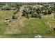 Expansive aerial shot showcasing a verdant acreage property with mature trees in a peaceful neighborhood at 12196 W Belleview Dr, Littleton, CO 80127