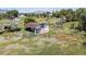 Aged barn with red trim surrounded by overgrown vegetation and rolling hills at 12196 W Belleview Dr, Littleton, CO 80127