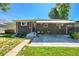 Brick home exterior featuring concrete patio with backyard and covered awning at 7011 Poplar St, Commerce City, CO 80022
