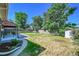 View of the home's backyard, featuring grass, fence and shed at 7011 Poplar St, Commerce City, CO 80022