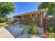 Home's covered patio with lush backyard and grass at 7011 Poplar St, Commerce City, CO 80022