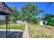 Exterior of home with a long concrete walkway, lush yard and fence at 7011 Poplar St, Commerce City, CO 80022
