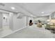 A view into the expansive basement living space with access to a modern bathroom at 7011 Poplar St, Commerce City, CO 80022