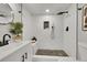 Modern bathroom featuring sleek fixtures, stone tile flooring in shower and a rainfall showerhead at 7011 Poplar St, Commerce City, CO 80022