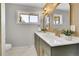 Modern bathroom showcasing dual sinks, white countertops, and sleek gold fixtures and hardware at 7011 Poplar St, Commerce City, CO 80022