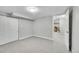 Neutrally decorated bedroom, with new carpet, includes doorway to adjoining living space at 7011 Poplar St, Commerce City, CO 80022