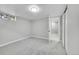Empty bedroom with new carpet and a glimpse into the adjacent living area at 7011 Poplar St, Commerce City, CO 80022