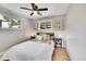 Cozy bedroom with hardwood floors, ceiling fan, and natural light at 7011 Poplar St, Commerce City, CO 80022