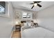 Charming bedroom with light gray walls, ceiling fan, a comfy bed with multiple pillows, and hardwood floors at 7011 Poplar St, Commerce City, CO 80022