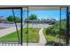Framed view from the front porch showcasing the landscaped yard and neighboring houses across the street at 7011 Poplar St, Commerce City, CO 80022