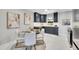 Modern eat-in kitchen features modern cabinets, stainless steel appliances, and stylish light fixture at 7011 Poplar St, Commerce City, CO 80022