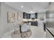 Eat-in kitchen features modern cabinets, stainless appliances, and stylish dining set at 7011 Poplar St, Commerce City, CO 80022