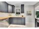 Modern kitchen features dark cabinets, stainless steel appliances, and wood countertop at 7011 Poplar St, Commerce City, CO 80022