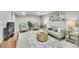 A stylish living room featuring neutral tones, plush seating, a round coffee table and modern art at 7011 Poplar St, Commerce City, CO 80022