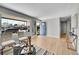 Bright living room with hardwood floors, stylish furniture, and a front door at 7011 Poplar St, Commerce City, CO 80022