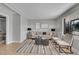 Bright living room features hardwood floors, neutral paint, large window, and stylish furniture at 7011 Poplar St, Commerce City, CO 80022