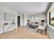 Bright living room with hardwood floors, neutral walls, stylish furniture, and ample natural light at 7011 Poplar St, Commerce City, CO 80022
